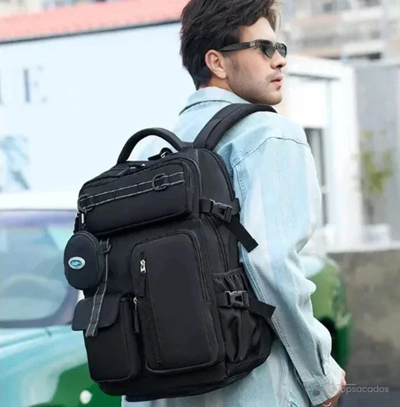 Sac à dos 25l noir porté par un homme en extérieur urbain, montrant le port confortable sur les épaules