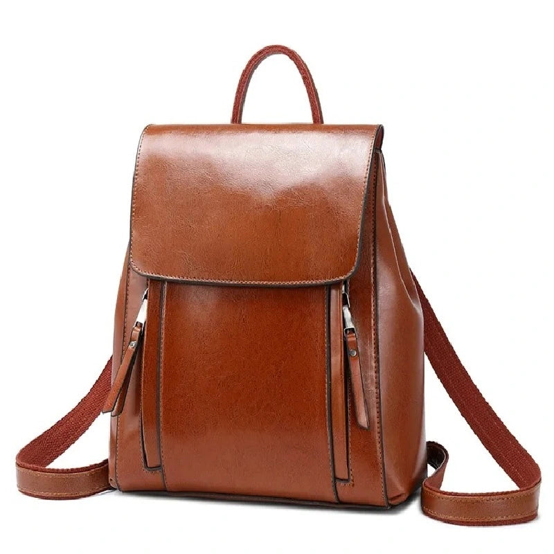 Sac à dos antivol Femme cuir marron clair avec finition lisse, bretelles ajustables et doubles poches zippées à l'avant, présenté sur fond blanc.