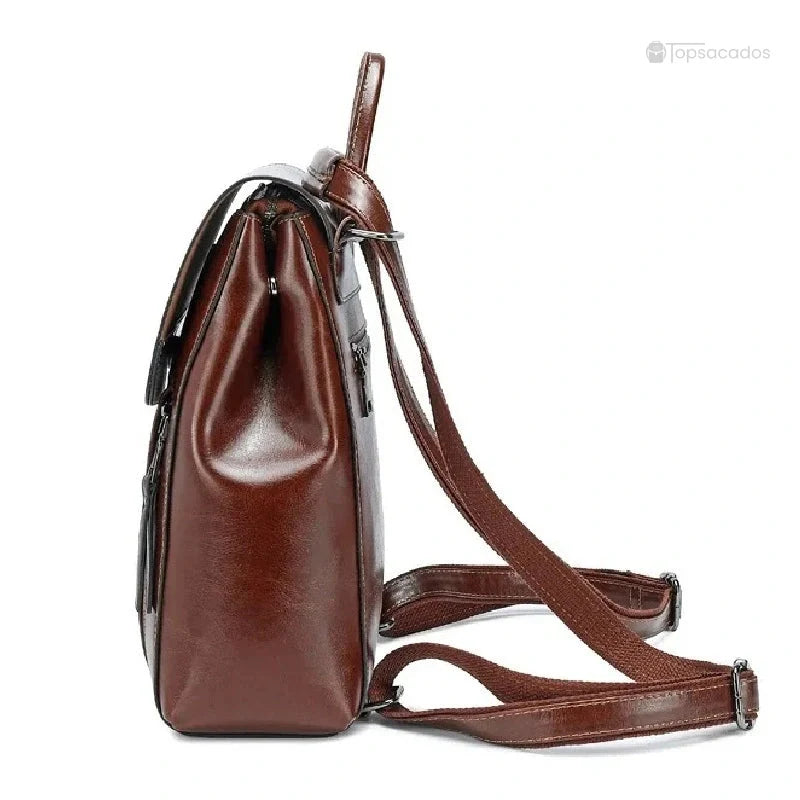 Sac à dos antivol Femme cuir marron vu de profil, montrant la structure verticale et les bretelles réglables.