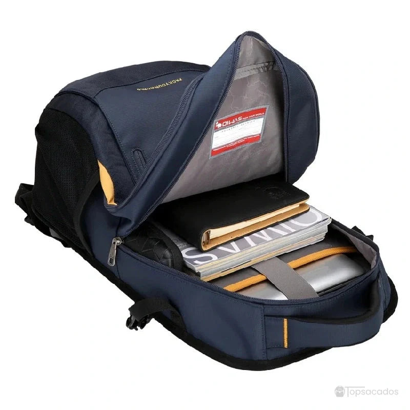 sac a dos college garcon ouvert montrant des livres, une tablette et une pochette dans le compartiment principal