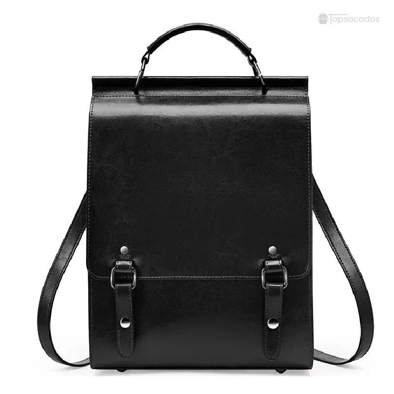 Sac à dos cuir Femme avec rabat noir en cuir rigide, posé sur fond blanc, avec poignées et sangles visibles