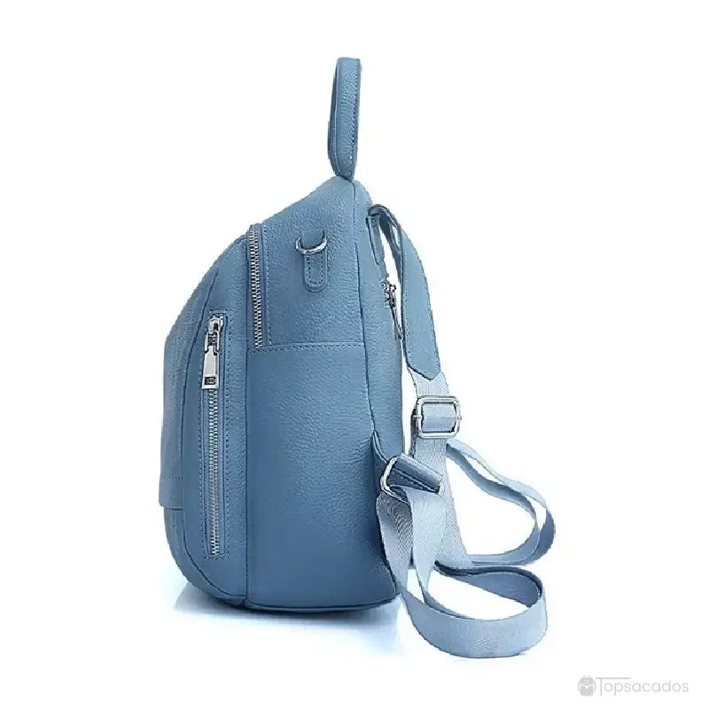Sac à dos femme chic bleu vu de profil, avec fermetures zippées latérales et lanières ajustables