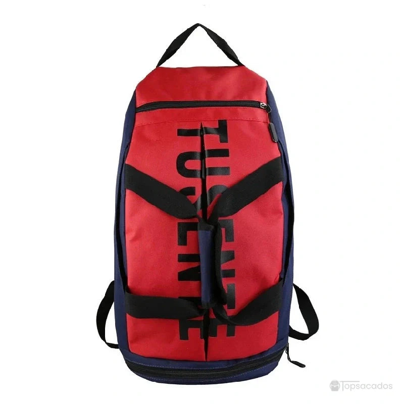 Sac à dos foot rouge et bleu avec logo noir, posé debout sur fond blanc.