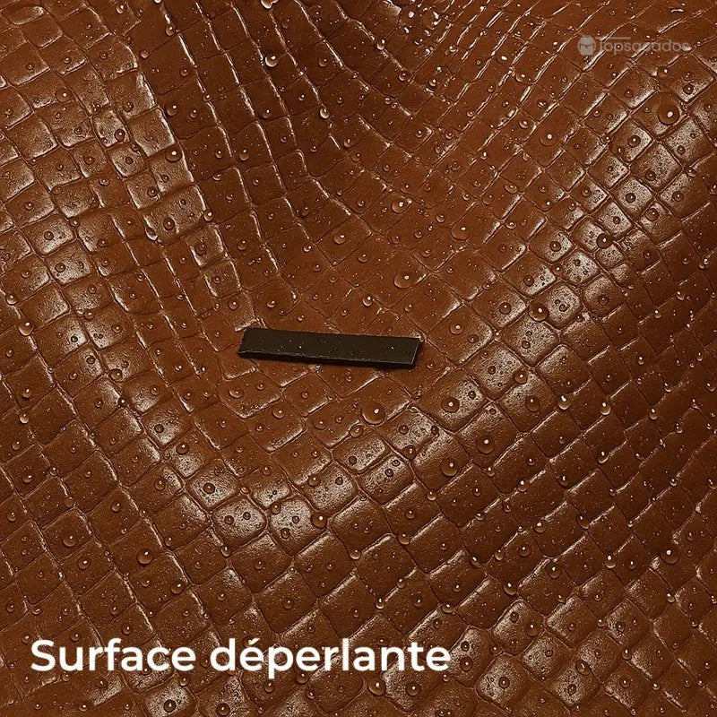 Sac à dos marron Femme avec gros plan sur la surface tressée déperlante, couverte de gouttes d’eau visibles.