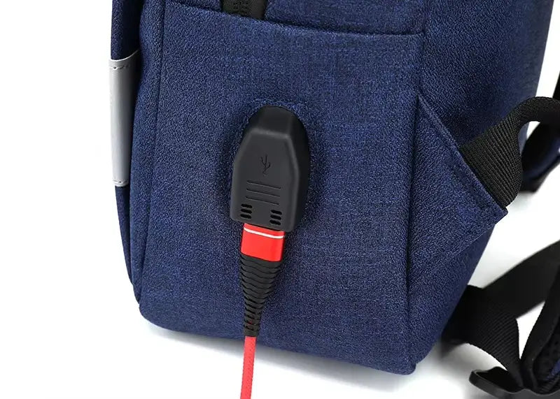 Sac à dos ordinateur Homme avec zoom sur le port USB intégré sur le côté, câble rouge connecté.