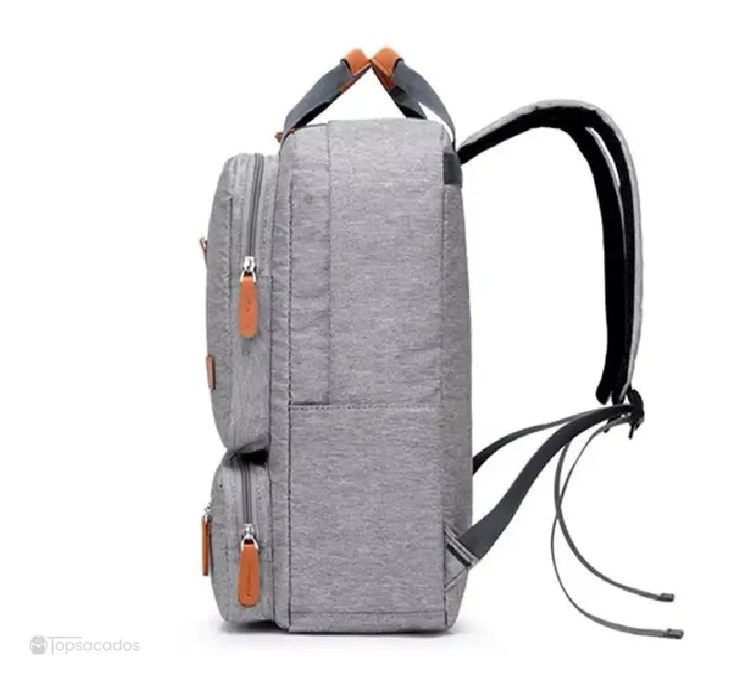 Sac à dos pour lycéen gris vu de profil avec bretelles ajustables et poches frontales en relief.