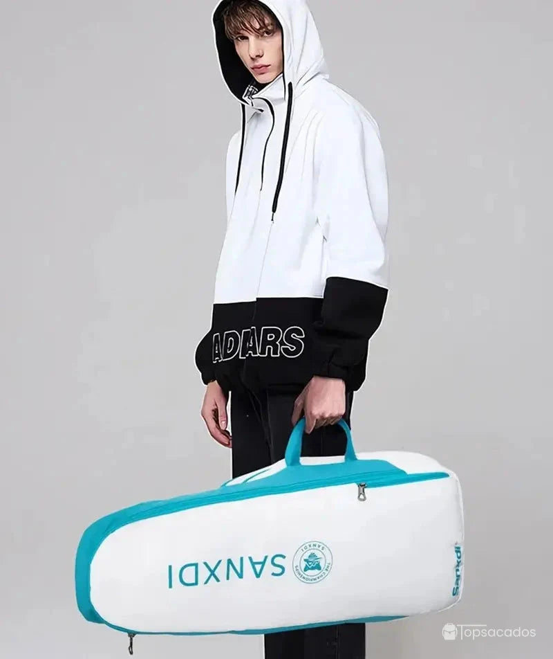 Sac à dos tennis en version sac de sport porté par un homme en hoodie, parfait pour transporter tout l’équipement de tennis.