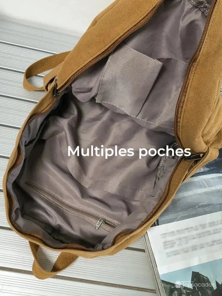 Sac à dos toile marron ouvert montrant l'intérieur spacieux avec multiples poches et fermeture éclair