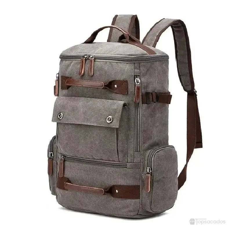 Sac à dos vintage homme gris en toile résistante avec multiples poches zippées et finitions en cuir foncé.