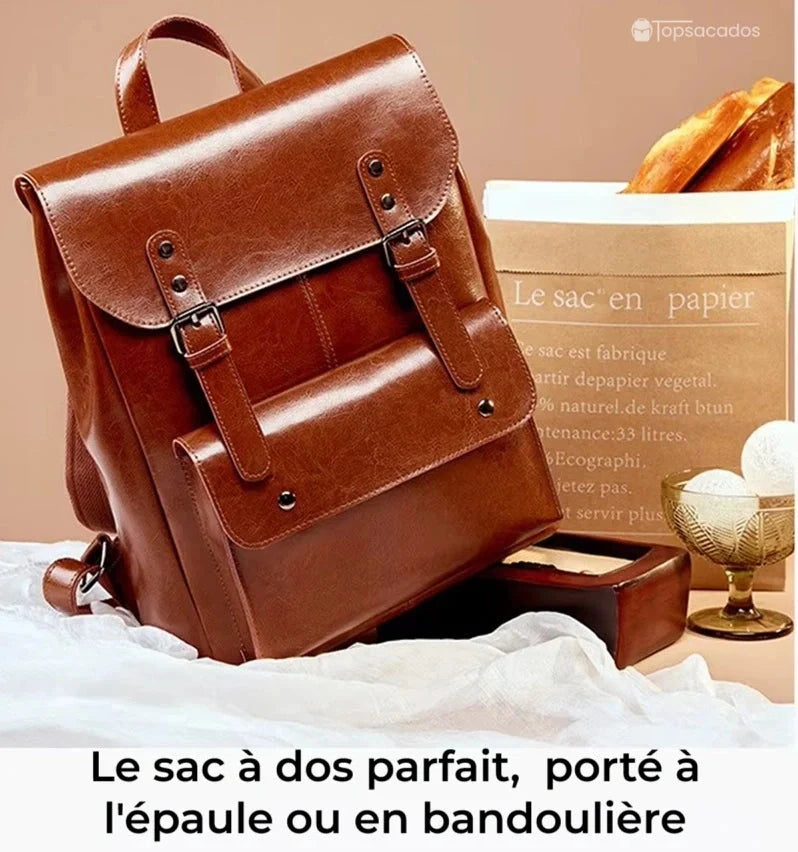 Sac à dos vintage pour femme posé sur un drap blanc, ambiance chaleureuse avec pain et déco rétro en arrière-plan, idéal pour une utilisation quotidienne.