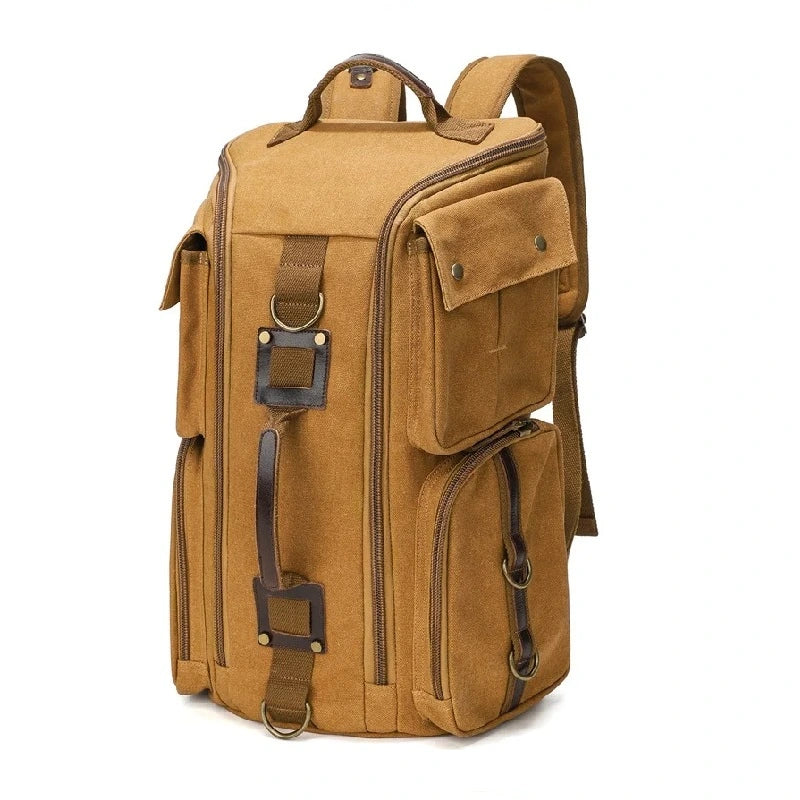 Sac à dos vintage marron en toile avec poches latérales et détails en cuir, présenté sur fond blanc