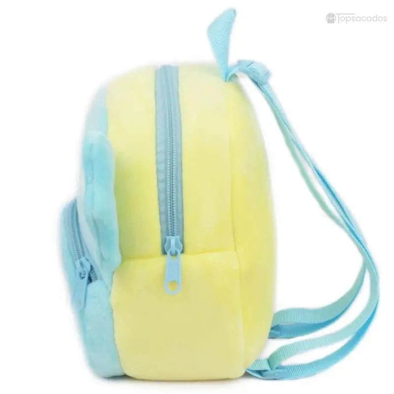 Sac à dos Bébé vu de côté, montrant l'épaisseur de la peluche jaune et les deux fermetures éclairs superposées.
