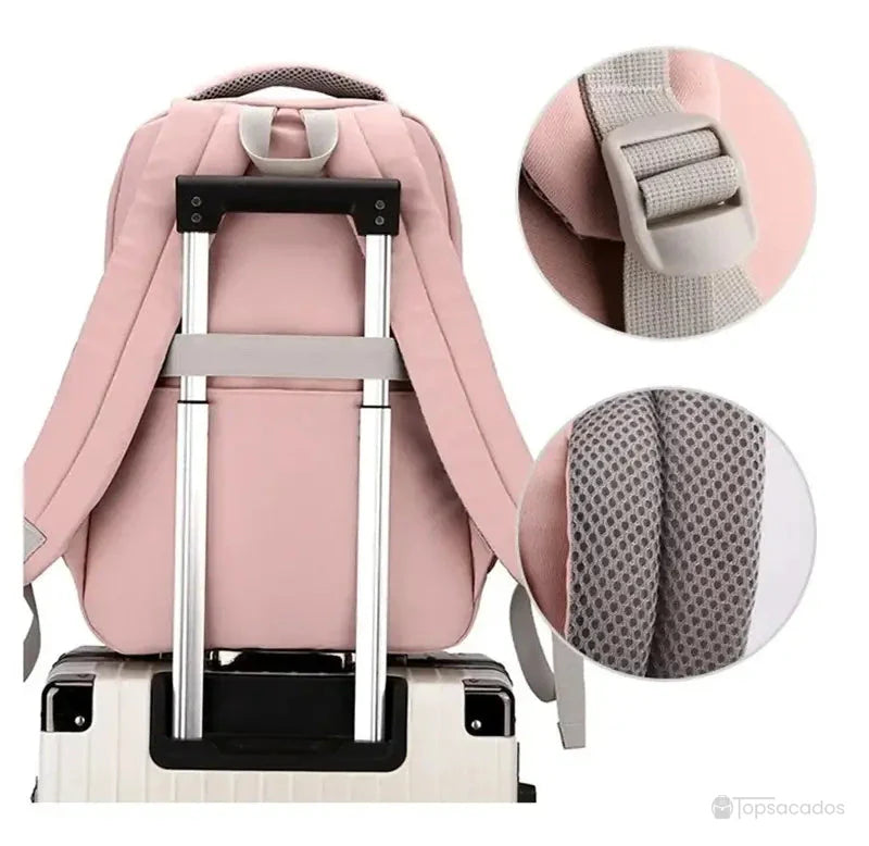 Sac à dos école rose fixé sur poignée de valise trolley avec zoom sur bretelles rembourrées.