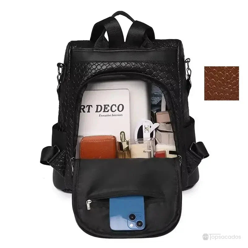 Sac à dos marron Femme en version noire, montré ouvert avec intérieur compartimenté contenant des objets du quotidien.