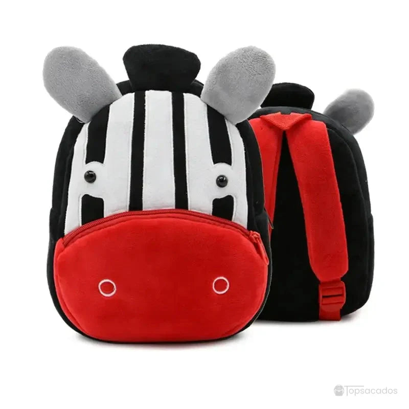 Sac à dos maternelle fille noir et blanc en peluche avec rayures de zèbre et museau rouge vif, bretelles rouges contrastantes à l’arrière.