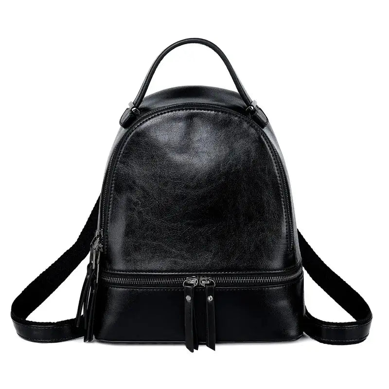 Sac à dos pour femme en cuir noir brillant, design arrondi élégant avec deux fermetures éclair frontales, présenté sur fond blanc.