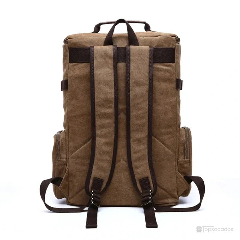 Sac à dos vintage homme vu de dos avec bretelles longues, renforts visibles et sangles tombantes sur fond blanc.