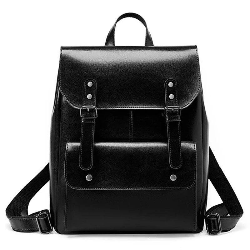 Sac à dos vintage pour femme en simili cuir noir élégant, photographié de face sur fond blanc, avec finitions soignées et boucles argentées.